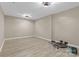 A bonus room with ample space for a workout area with modern lighting at 5916 Cashion Rd, Huntersville, NC 28078