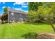 Spacious backyard featuring a lush green lawn, mature tree, and patio furniture, perfect for outdoor living at 622 Lorain Nw Ave, Concord, NC 28027