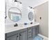 Contemporary bathroom with a white shiplap accent wall, dual sinks, and sleek fixtures at 622 Lorain Nw Ave, Concord, NC 28027