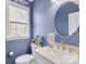 Charming bathroom featuring a stylish mirror, sink, and window at 622 Lorain Nw Ave, Concord, NC 28027
