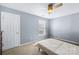 This cozy bedroom has a neutral color palette, plush carpeting, and a ceiling fan for added comfort at 622 Lorain Nw Ave, Concord, NC 28027