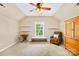Cozy bedroom with neutral walls and carpet featuring natural light, reading nook, and armoire at 622 Lorain Nw Ave, Concord, NC 28027