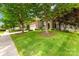 Beautiful home exterior with lush landscaping, mature trees, and well-maintained lawn along a sidewalk at 622 Lorain Nw Ave, Concord, NC 28027