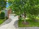 Attractive home featuring brick and siding accents, a two-car garage, mature trees, and a well-maintained lawn at 622 Lorain Nw Ave, Concord, NC 28027
