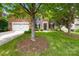 Charming two-story home featuring a lush front yard, brick accents, and a welcoming entrance with a blue door at 622 Lorain Nw Ave, Concord, NC 28027