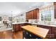 Spacious kitchen boasts dark wood cabinetry, stainless steel appliances, and a butcher block island with eat in kitchen table at 622 Lorain Nw Ave, Concord, NC 28027