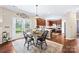 Cozy kitchen and dining area showcases dark wood cabinets and a table with doors that lead to backyard at 622 Lorain Nw Ave, Concord, NC 28027