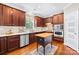 Well-lit kitchen features stainless steel appliances, dark wood cabinets, and a butcher block island at 622 Lorain Nw Ave, Concord, NC 28027