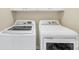 Laundry room featuring a side-by-side washer and dryer beneath white cabinets at 622 Lorain Nw Ave, Concord, NC 28027