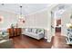 Inviting living room with hardwood floors, a grey sofa, decorative accents, and staircase to the second floor at 622 Lorain Nw Ave, Concord, NC 28027