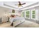 Spacious main bedroom features a tray ceiling, fan, and plenty of light from the windows at 622 Lorain Nw Ave, Concord, NC 28027