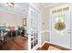 Bright office space featuring hardwood floors, glass doors, a decorative front door, and stylish furniture at 622 Lorain Nw Ave, Concord, NC 28027
