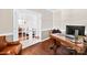 Office with a large wooden desk, leather chair, hardwood floors, and a view into the adjoining living room at 622 Lorain Nw Ave, Concord, NC 28027