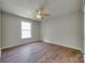 Cozy bedroom features a ceiling fan, neutral walls, and wood-look laminate flooring at 672 Carybrook Ct, York, SC 29745