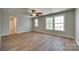 Primary bedroom with hardwood floors, ceiling fan, and natural light from windows at 672 Carybrook Ct, York, SC 29745