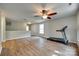 Spacious bonus room with hardwood floors, ceiling fan, and a treadmill at 672 Carybrook Ct, York, SC 29745