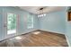Bright dining area with hardwood floors, modern light fixture, and a glass door leading outside at 672 Carybrook Ct, York, SC 29745