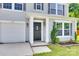 Welcoming entryway with a black front door, white trim, and a small garden area at 672 Carybrook Ct, York, SC 29745