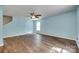 Bright living room with hardwood floors, ceiling fan, and a large window for natural light at 672 Carybrook Ct, York, SC 29745