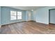 Inviting living room featuring hardwood floors, large windows for natural light, and a calming blue wall color at 672 Carybrook Ct, York, SC 29745