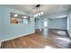 Open-concept living room featuring hardwood floors, modern lighting, and an opening to the kitchen area at 672 Carybrook Ct, York, SC 29745