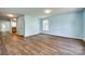 Open-concept living room featuring wood floors, natural light, and a seamless flow into the kitchen area at 672 Carybrook Ct, York, SC 29745