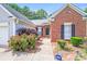 Inviting home entrance with a decorative wreath, manicured shrubs, and a pathway leading to the front door at 7033 Spandril Ln, Charlotte, NC 28215