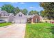 Charming home featuring a two-car garage, a well-maintained lawn, and a basketball hoop for recreational activities at 7033 Spandril Ln, Charlotte, NC 28215