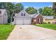 Charming home featuring a two-car garage, a well-maintained lawn, and a basketball hoop for recreational activities at 7033 Spandril Ln, Charlotte, NC 28215