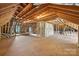 Spacious unfinished attic featuring exposed wooden beams, insulation, and a plywood floor at 7319 Stonehaven Dr, Waxhaw, NC 28173
