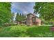 Beautiful brick home with a manicured lawn, mature trees, and an inviting screened-in porch at 7319 Stonehaven Dr, Waxhaw, NC 28173