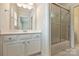 Well-lit bathroom featuring a glass-enclosed shower and vanity with white cabinetry at 7319 Stonehaven Dr, Waxhaw, NC 28173