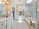 Bright bathroom featuring a large soaking tub, glass shower, and double vanity with a skylight at 7319 Stonehaven Dr, Waxhaw, NC 28173