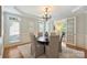 Refined dining room with modern chandelier, neutral decor, and french door access at 7319 Stonehaven Dr, Waxhaw, NC 28173