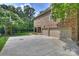Brick home exterior featuring an attached garage, basketball hoop and covered patio at 7319 Stonehaven Dr, Waxhaw, NC 28173