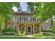 Elegant brick home featuring a charming balcony, manicured lawn, and tasteful landscaping at 7319 Stonehaven Dr, Waxhaw, NC 28173