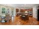 Spacious kitchen featuring hardwood floors, central island with granite countertops, and stainless appliances at 7319 Stonehaven Dr, Waxhaw, NC 28173