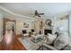 Inviting living room with hardwood floors, fireplace, and built-in shelves for a comfortable and stylish living space at 7319 Stonehaven Dr, Waxhaw, NC 28173