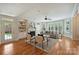 Bright living room with fireplace, built-in shelves, ceiling fan, hardwood floors, and lots of natural light at 7319 Stonehaven Dr, Waxhaw, NC 28173