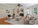 Cozy living room with hardwood floors, fireplace, and built-in shelves, perfect for relaxation and entertainment at 7319 Stonehaven Dr, Waxhaw, NC 28173