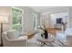 Bright living room featuring white armchairs and large windows with custom shutters at 7319 Stonehaven Dr, Waxhaw, NC 28173