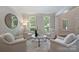 Cozy living room showcasing neutral decor, accent rug, and plantation shutters at 7319 Stonehaven Dr, Waxhaw, NC 28173