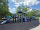 Community playground featuring a slide, climbing structures, and protective black rubber mulch at 7319 Stonehaven Dr, Waxhaw, NC 28173