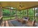 Relaxing screened-in porch with outdoor furniture, a ceiling fan and backyard views at 7319 Stonehaven Dr, Waxhaw, NC 28173