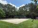 Community sand volleyball court surrounded by a white fence and lush trees at 7319 Stonehaven Dr, Waxhaw, NC 28173