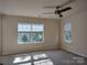 Inviting bedroom featuring neutral walls, ceiling fan, and natural light at 7323 Jane Parks Way, Charlotte, NC 28217