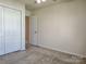 Inviting bedroom with soft carpeting and a doorway leading to another room at 7323 Jane Parks Way, Charlotte, NC 28217