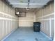 Spacious garage interior with an overhead storage rack, and painted walls and flooring at 7323 Jane Parks Way, Charlotte, NC 28217