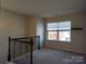Upstairs hallway with natural light and a view of the outdoors at 7323 Jane Parks Way, Charlotte, NC 28217