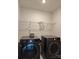 Functional laundry room with modern LG washer and dryer and useful storage shelf at 7323 Jane Parks Way, Charlotte, NC 28217